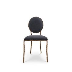 an upholstered chair with a round back and metal frame, against a white background