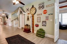 there is a large clock on the wall in this room with many signs and decorations