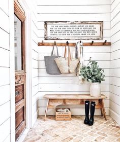 a wooden bench sitting next to a wall with two purses hanging on it's hooks