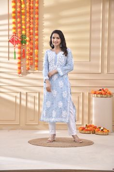 Our Chikankari Mulmul Straight Kurta Set is crafted from high-quality cotton for superior comfort and fit. It features a relaxed fit that's perfect for everyday wear. Experience the utmost comfort without compromising an elegant style! Features: Long kurta in soft (mulmul) cotton fabric Hand-embroidered with Chikankari (Ghasspatti Work)  work Our model is wearing size S and is 5 feet 5 inches tall. Length: Kurta - 47" inches |  Fabric: Pure Soft Cotton Embroidery : Chikankari ghasspatti work Col Diwali Chikankari Embroidery Mulmul Kurta, Straight Kurta With Chikankari Embroidery For Navratri, Traditional White Lawn Suit With Block Print, Festival Kurta With Chikankari Embroidery In Mulmul, Mulmul Kurta With Chikankari Embroidery For Festivals, Straight Kurta With Chikankari Embroidery, Chikankari Embroidery Mulmul Kurta For Diwali, White Long Sleeve Block Print Traditional Wear, Festival Mulmul Kurta With Chikankari Embroidery