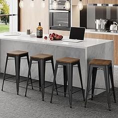 a modern kitchen with marble counter tops and bar stools