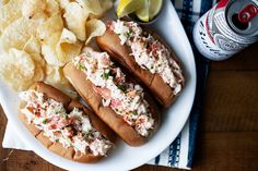 two hot dogs with cole slaw and chips on a plate