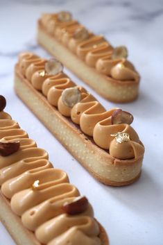 three desserts with peanut butter frosting and nuts arranged on top of each other