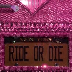 a pink license plate with the word ride or die on it