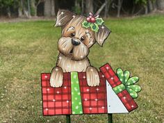 a wooden sign with a dog holding a present