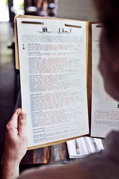 a person holding up a paper with writing on it