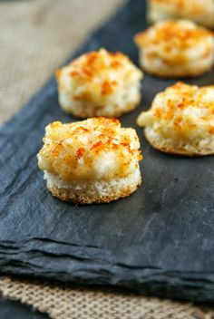 small appetizers are sitting on a black cloth