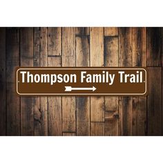 a sign that says,'thomas family trail'on the side of a wooden wall