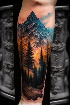 a man's arm with a mountain scene on it and trees in the foreground