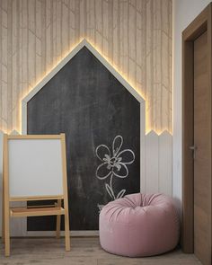 a chalkboard in the corner of a room next to a pink bean bag chair