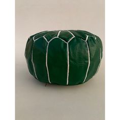 a green leather poufce with white lines on it