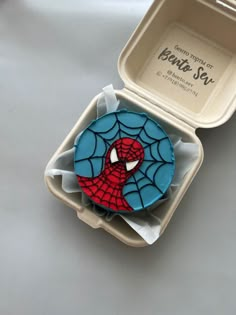 a spiderman cookie in a plastic container