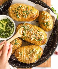 baked potatoes with pesto sauce in a cast iron skillet