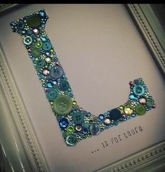 the letter j is made up of buttons and beads