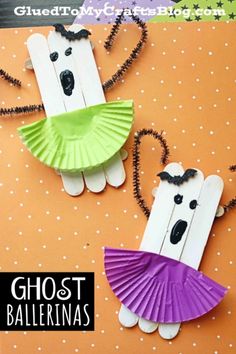 two popsicle ghost puppets made from construction paper