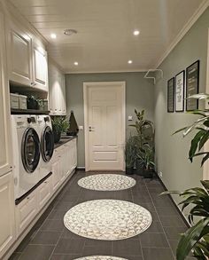 two rugs on the floor in front of a washer and dryer