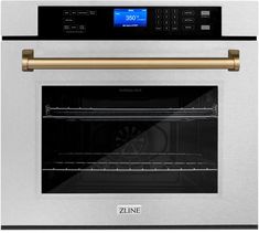 a stainless steel oven with the door open and gold handle on it's side