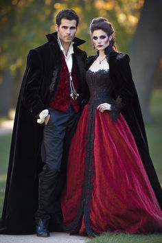 a man and woman dressed up as dracula and vampire bride in formal dress standing next to each other