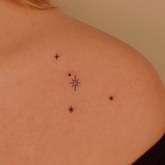 the back of a woman's shoulder with stars on it