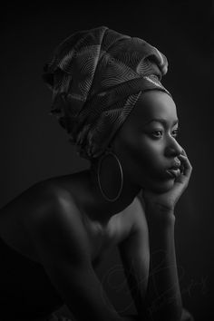 a black and white photo of a woman wearing a turban