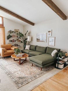 a living room filled with furniture and a rug on top of a hard wood floor