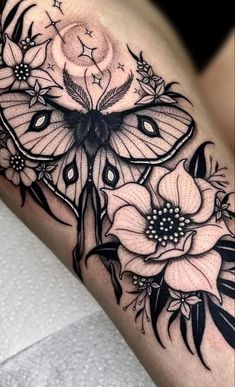 a black and white butterfly with flowers on it's thigh, next to the word hystgramm