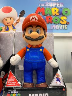 the mario bros movie character is on display in a box with other toys behind it