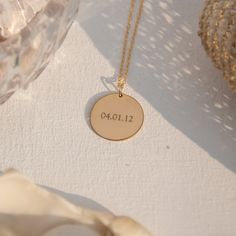 "Think of the statement that you wish to make as our 14K gold filled disk is large enough to engrave up to 9 letters - so you can opt for a name, initials, or even a word that holds great meaning for you. Simple and uncomplicated, the shiny-finish pendant hangs from a delicate chain in matching gold that comes in your choice of 16, 18, or 20-inch lengths. Free Engraving for a limited time! NECKLACE DETAILS ⚬ 14k gold-filled disk and chain. ⚬ Disk measures 3/4\" (19mm). ⚬ Chain in your choice of Stamped 14k Gold Round Necklace, Gold Minimalist Jewelry With Laser Engraving, Minimalist Gold Necklace With Laser Engraving, Gold Laser Engraved Necklaces For Anniversary, Laser Engraved Round Yellow Gold Necklace, Everyday Gold Necklaces With Engraved Text, 14k Gold Jewelry With Engraved Text, Gold Laser Engraved Necklace For Anniversary, Laser Engraved Round Disc Necklaces For Anniversary