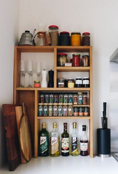 the shelves in this kitchen are filled with spices and condiments, such as liquor