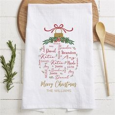 a christmas tea towel on a wooden board with a spoon and knife next to it