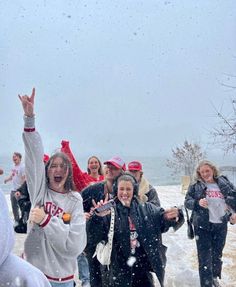 a group of people standing on top of snow covered ground