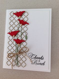 a card with three red flowers on it