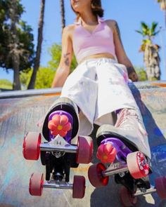 a woman is sitting on top of a skateboard