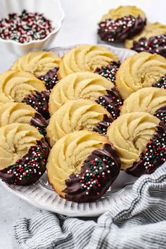 chocolate covered cookies with sprinkles on a plate