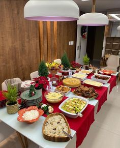 a long table with many plates and bowls on it that are covered in food items