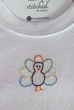 a white shirt with a turkey embroidered on it