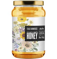 a jar of honey with flowers on the front and label that says texas farmhouse local