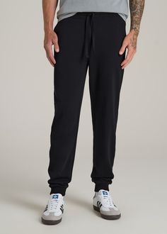 Relax In Style The Ultimate Extra-Long Men's Joggers Ready to meet your new favorite joggers? Our Wearever 2.0 Fleece Tall Men's Joggers are here to revolutionize your chill time. Designed for men over 6', these aren't just any joggers—they're your go-to for year-round comfort. Made from cozy fleece with a stretch fabric that moves with you, they offer a modern fit that's just right, not too tight. The updated trim, stylish drawstring, and thoughtful branding elevate these from basic to essentia Black Moisture-wicking Joggers For Loungewear, Black Joggers With Comfort Waistband For Jogging, Black Athleisure Sweats With Comfort Waistband, Black Sweatpants With Ribbed Cuffs For Gym, Black Tapered Leg Joggers Athleisure, Black Tapered Leg Joggers For Athleisure, Black Athleisure Joggers With Comfort Waistband, Black Sweatpants With Ribbed Waistband For Gym, Black Tapered Joggers With Ribbed Waistband