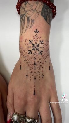 a woman's hand with a tattoo on it