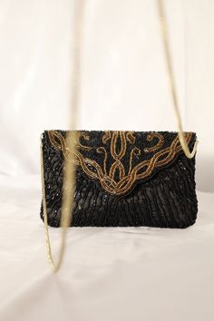 Glamorous & sophisticated black and gold beaded evening bag. The bag has a background of black taffeta. Front has large design of gold and black beading, with scallop flap and snap button closure. The back has black beads.  The bag interior is black with one pocket, spacious enough to hold an iPhone and lipstick. The beaded clutch bag also includes a gold cord chain strap to wear on your shoulder. Perfect for a glamorous special occasion or after five bag.   Vintage from 80's Height 5" Length 7. Elegant Sequin Bags For Night Out, Luxury Black Beaded Evening Bag, Black Beaded Evening Bag For Wedding, Black Sequin Evening Bag For Events, Elegant Black Sequined Evening Bag, Elegant Black Beaded Bags, Black Evening Bags With Sequins, Black Evening Bag With Sequins, Party Black Clutch With Sequins