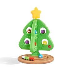 a green toy tree with lots of different colored balls on it's top and bottom