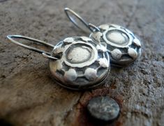 "\"Concho\" - I created these by taking a mold of one of the conchos on my saddle & casting it in silver.. perfect for the horse lover or western enthusiast! COMPONENTS/PROCESS: ~15mm cast replicas of one of my saddle conchos hand crafted of recycled fine silver (99% pure silver/sterling is 92.5% silver). As I construct each one entirely by hand sizes are approximate. My hand crafted sterling silver earwires. All given an oxidized polished finish. LENGTH: Including my handforged earwires is Artisan Oxidized Finish Earrings For Everyday, Handmade Antique Silver Round Earrings, Handmade Small Sterling Silver Earrings, Rustic Sterling Silver Jewelry In Silver, Silver Stamped Earrings For Everyday, Small Handmade Sterling Silver Earrings, Everyday Silver Stamped Earrings, Adjustable Stamped Dangle Earrings, Sterling Silver Dangle Earrings Stamped