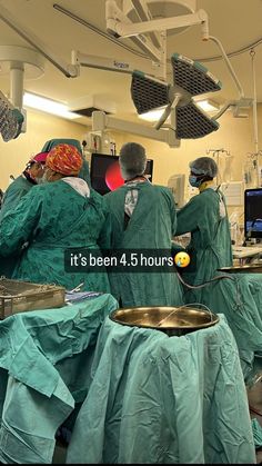 doctors in scrubs are performing surgery at the hospital