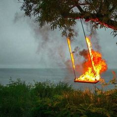 a fire is burning in the air on a swing