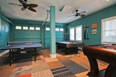 a game room with pool tables, air hockey and ping pong tables in it