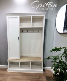 a large white closet with shelves and mirror