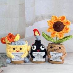 three small crocheted vases with flowers in them