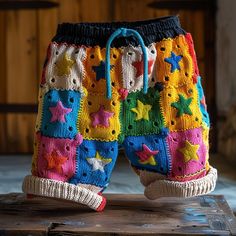 colorful knitted shorts sitting on top of a wooden table