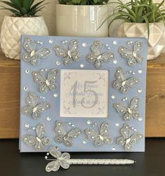 a blue frame with silver butterflies on it and a toothbrush in front of it