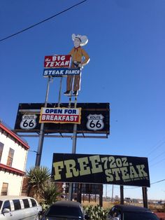 several signs on the side of a building advertising steaks